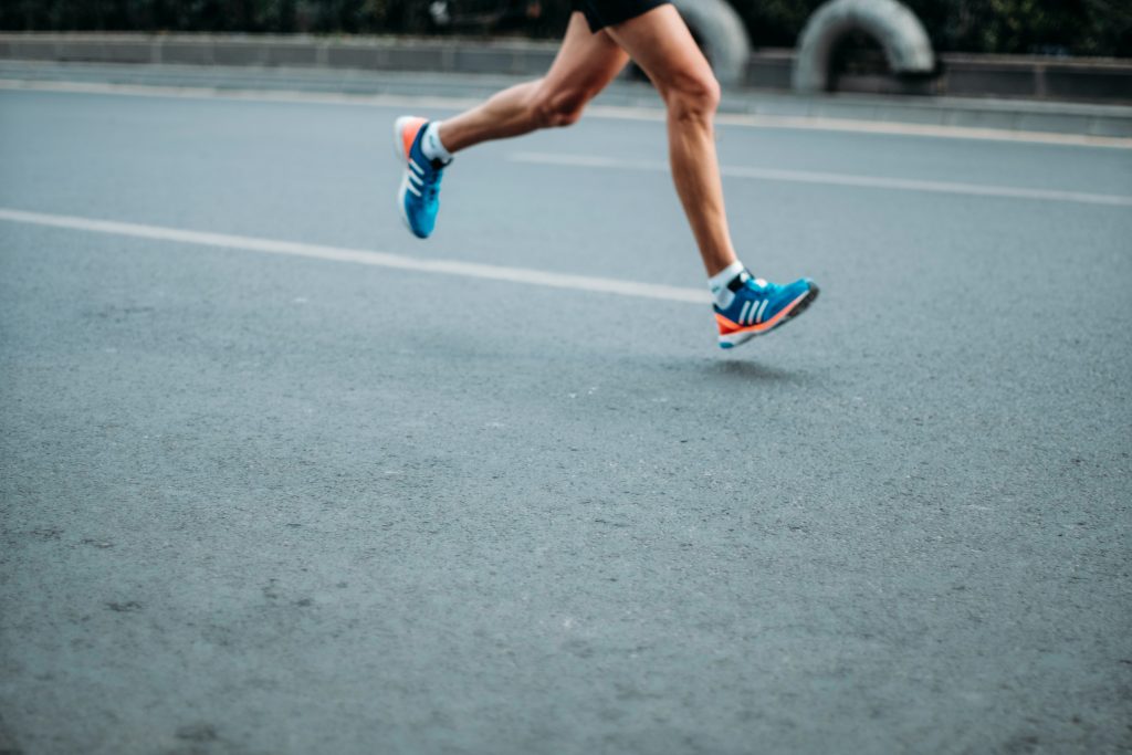 man running on pavement - endurance training. 
